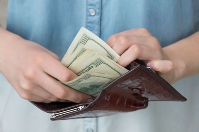 man counting money in wallet